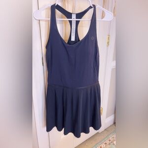 This is a Lululemon, size 10, and never worn tennis dress